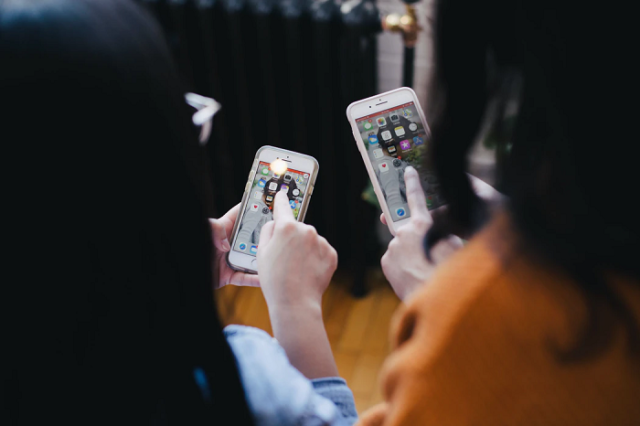 two-girls-using-mobile-phone